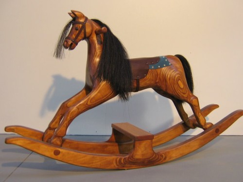 Small oak colored rocking horse on bow rocker
